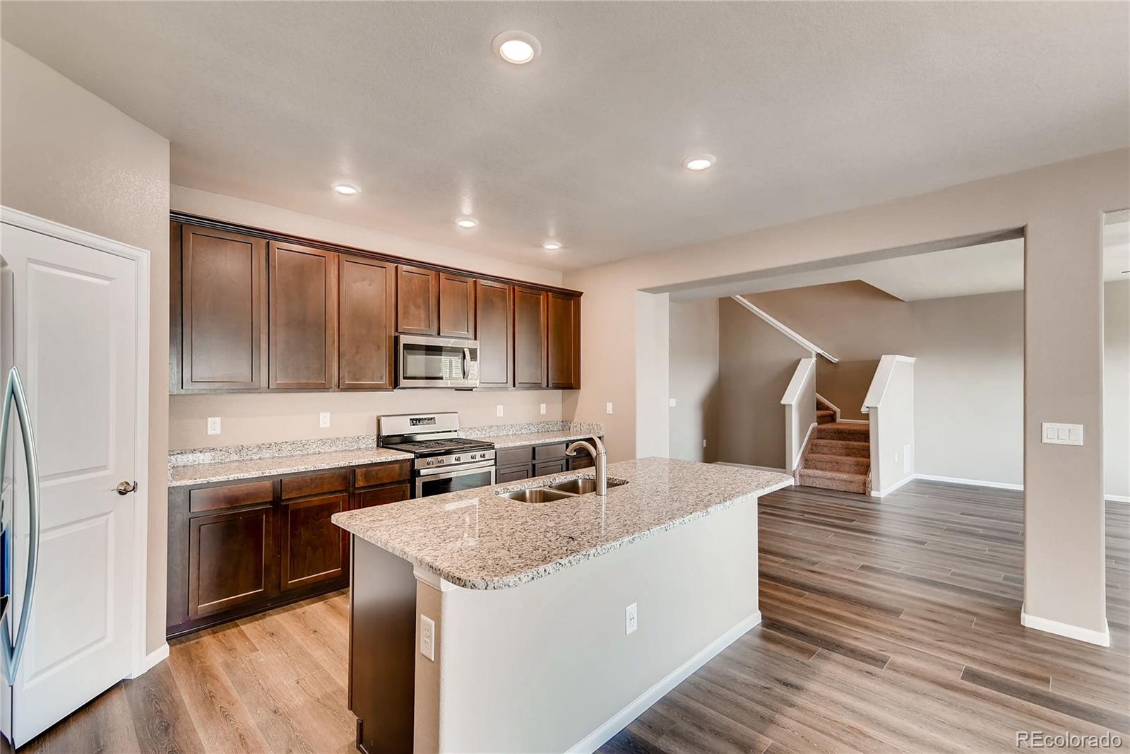 7132 Shavano Circle Frederick, CO 80504 - Photo 6 of 14 a kitchen with a sink and cabinets