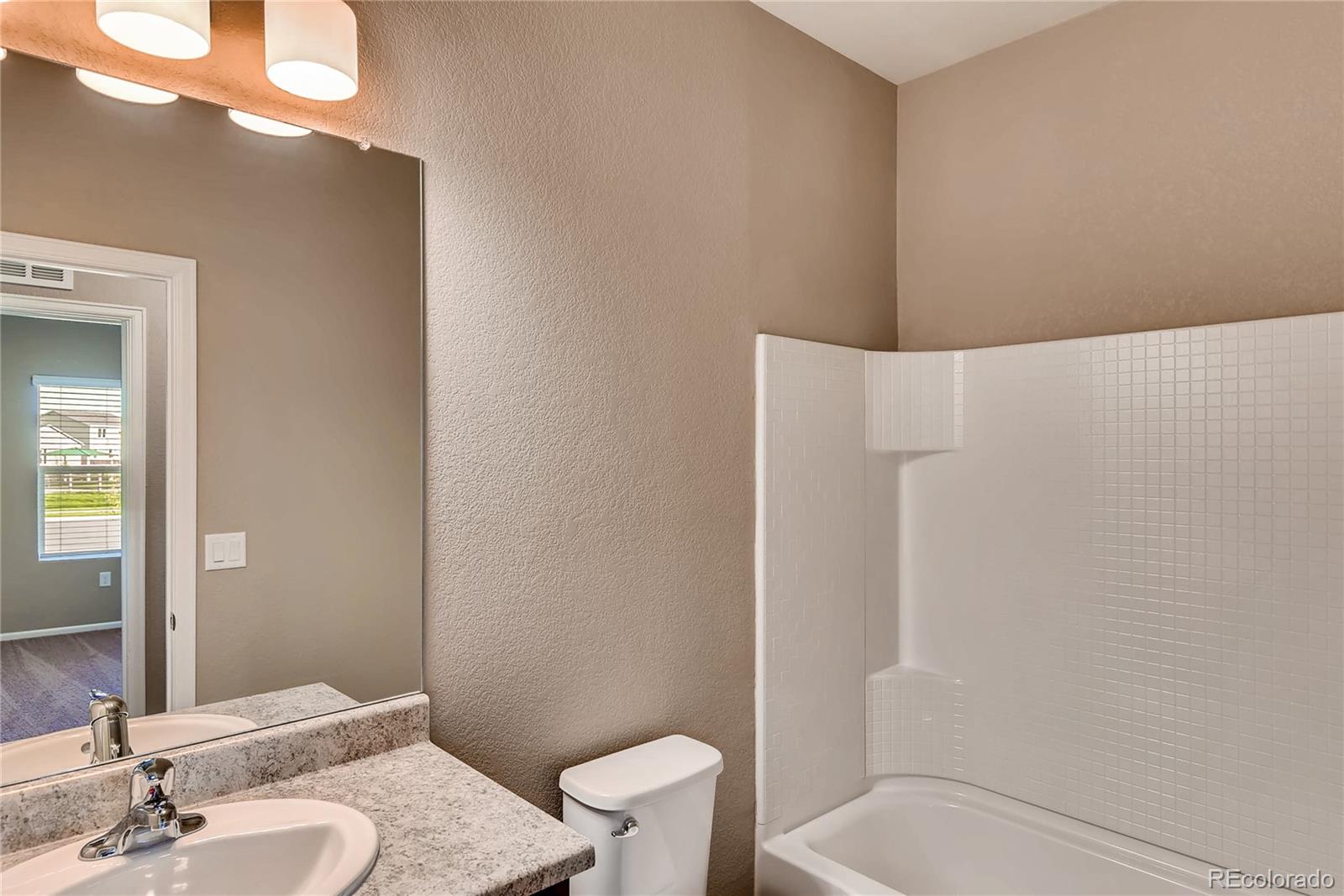 7132 Shavano Circle Frederick, CO 80504 - Photo 8 of 14 a bathroom with a sink a toilet and shower
