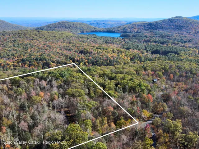 a view of a yard with wooden fence
