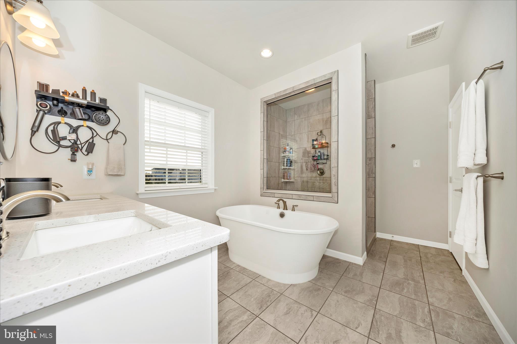 1600 Hobble Trail Frederick, MD 21702 - Photo 12 of 48 a spacious bathroom with a bathtub sink and mirror