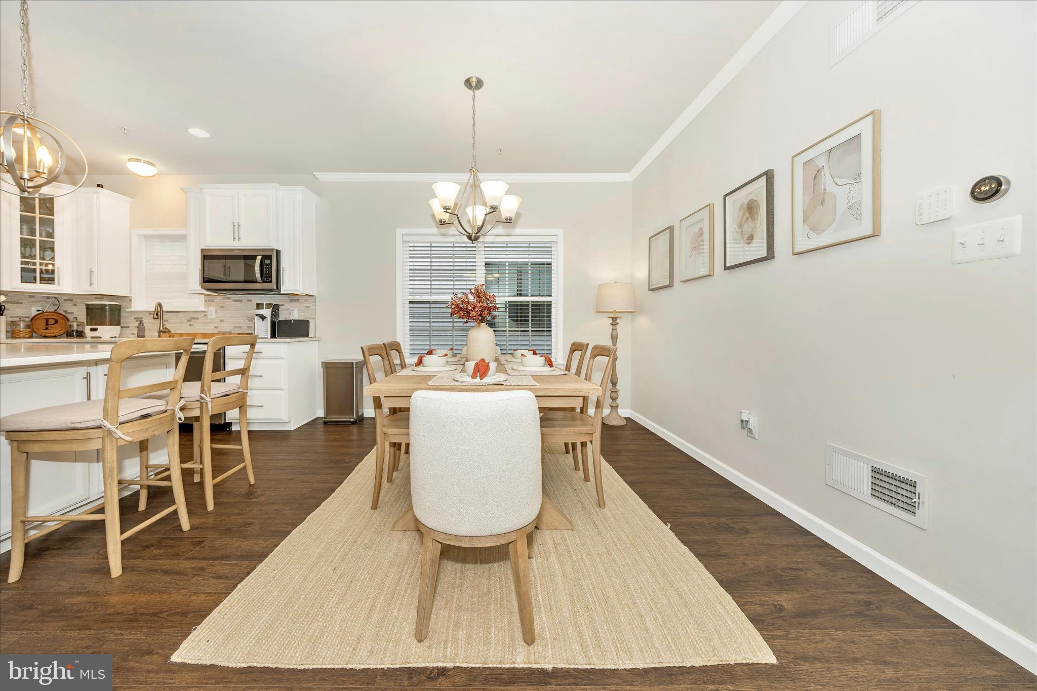 1600 Hobble Trail Frederick, MD 21702 - Photo 15 of 48 a dining room with wooden floor a chandelier a wooden table and chairs