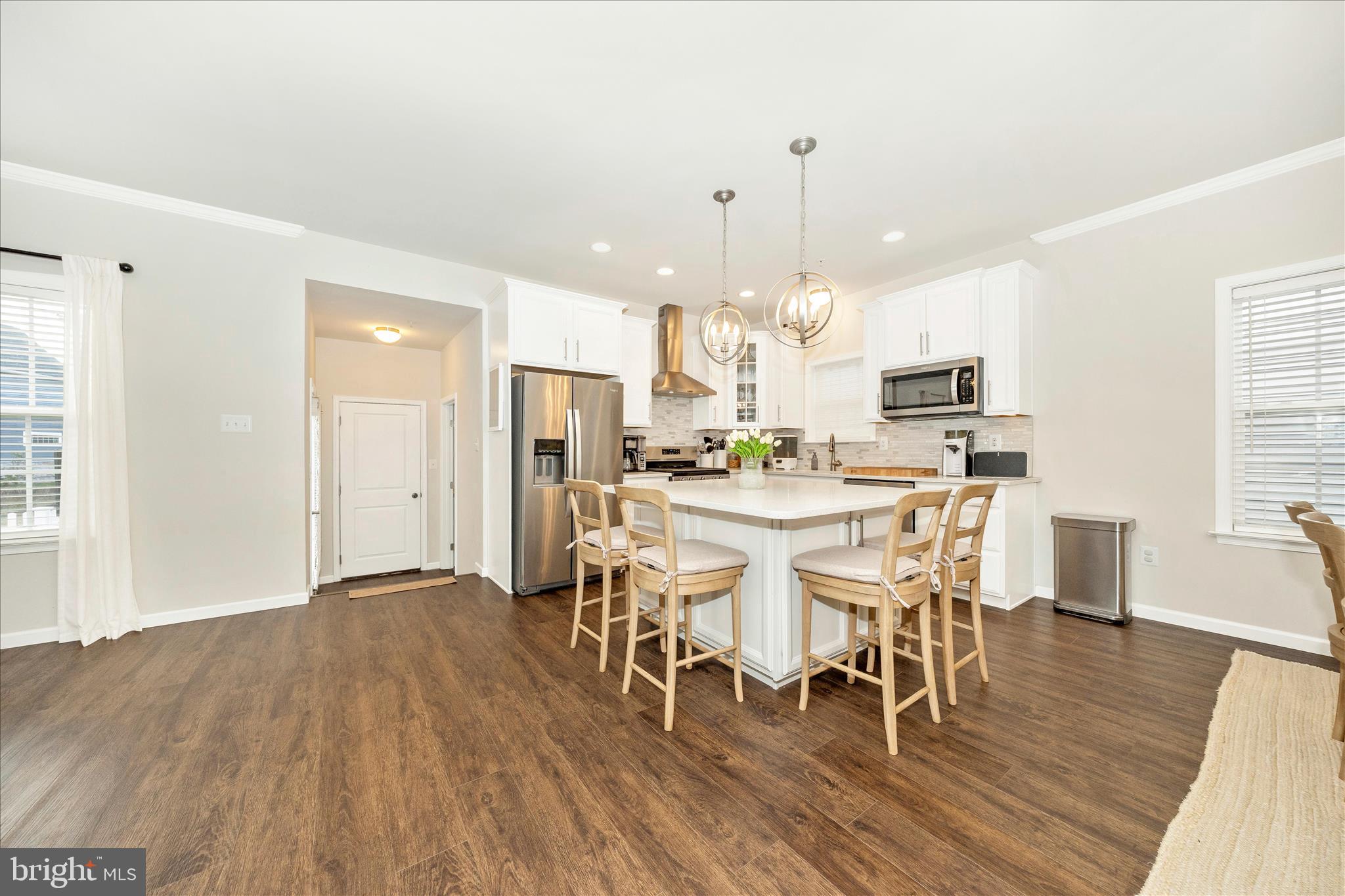 1600 Hobble Trail Frederick, MD 21702 - Photo 17 of 48 a dining room with furniture wooden floor a rug and a chandelier