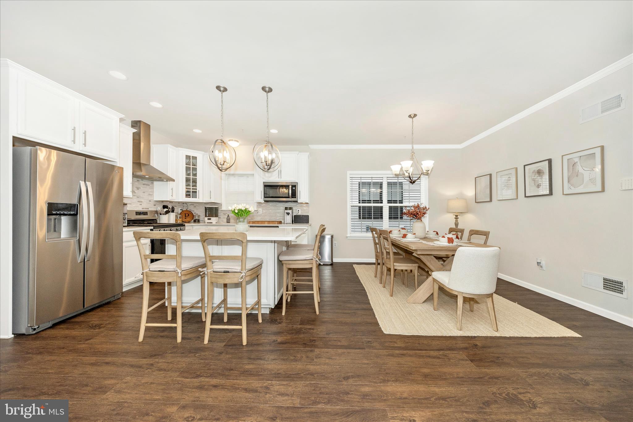 1600 Hobble Trail Frederick, MD 21702 - Photo 18 of 48 a dining room with stainless steel appliances kitchen island granite countertop a dining table chairs and a refrigerator