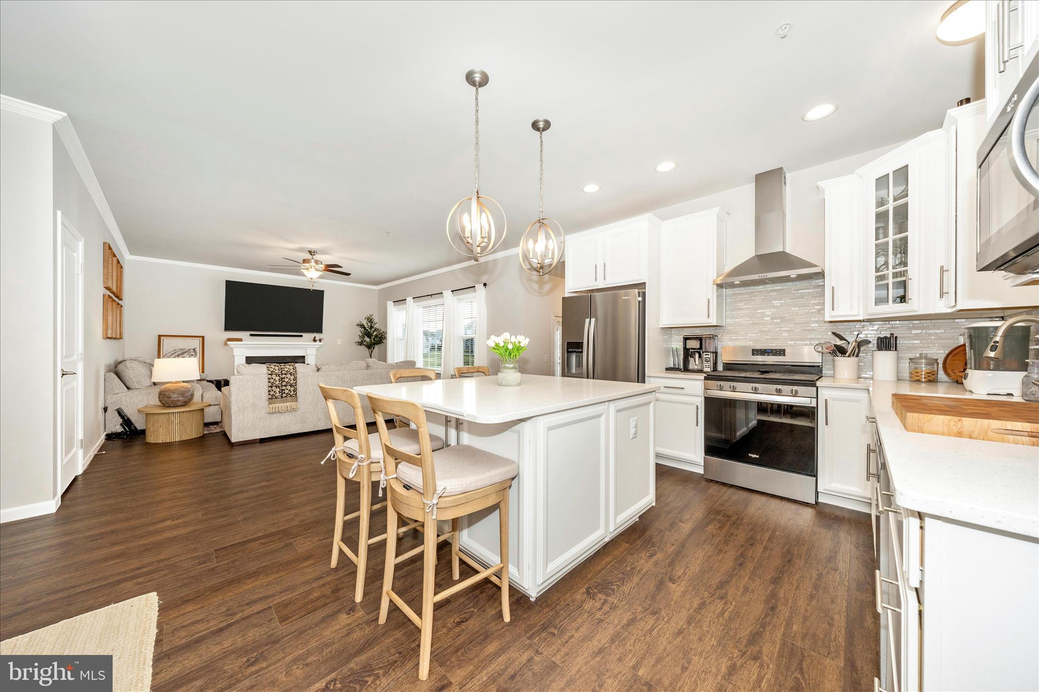 1600 Hobble Trail Frederick, MD 21702 - Photo 21 of 48 a large kitchen with stainless steel appliances kitchen island granite countertop a stove a sink dishwasher and a dining table with wooden floor