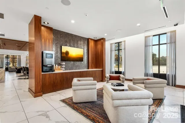 a living room with furniture and a chandelier