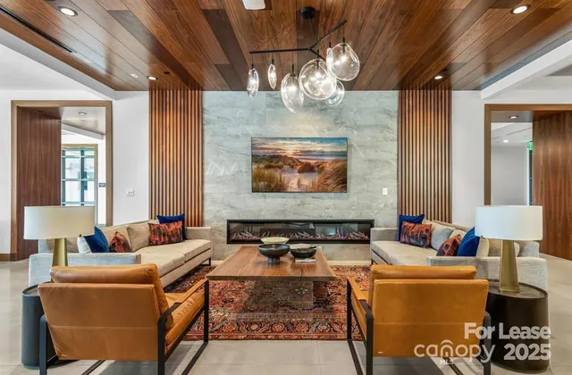 a view of a hallway with wooden floor and living room