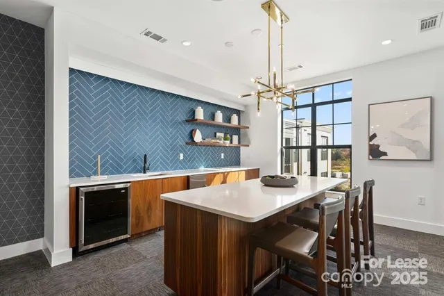 a living room with furniture a window and a flat screen tv