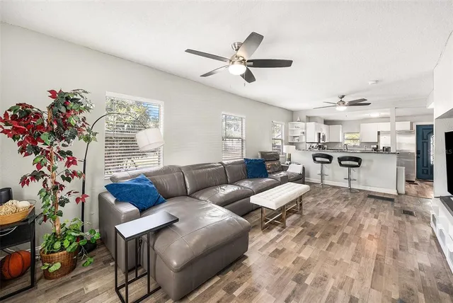 a living room with furniture fireplace and wooden floor