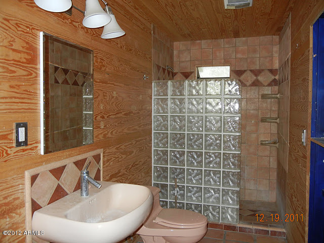 47421 North New River Road New River, AZ 85087 - Photo 10 of 23 a bathroom with a toilet a sink and mirror