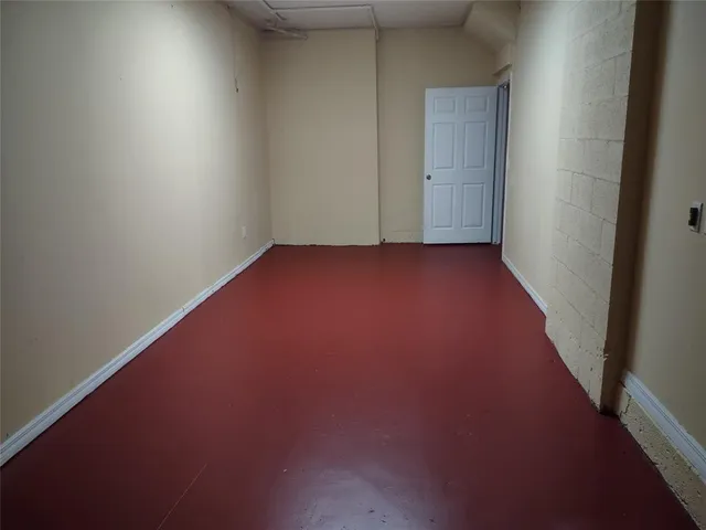 an empty room with wooden floor