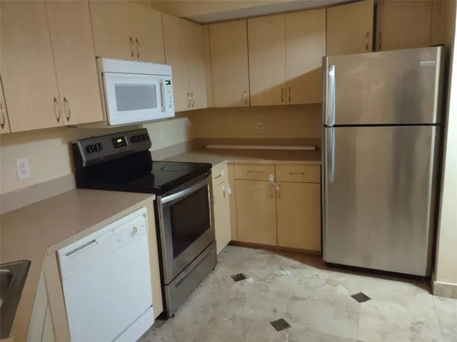 a kitchen with a refrigerator stove and microwave
