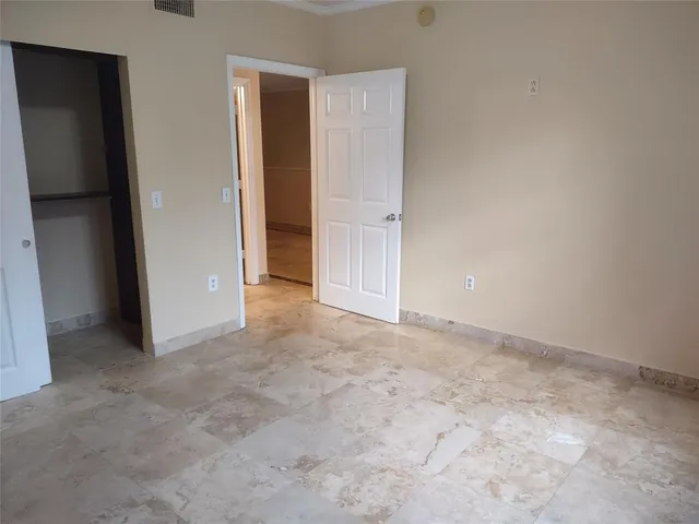 an empty room with closet area