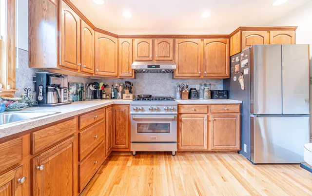 a living room with lots of furniture and view of kitchen