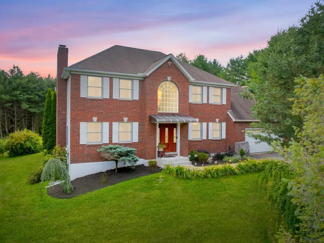 a front view of a house with a yard table and chairs
