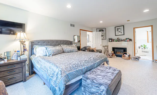 a bathroom with a granite countertop sink a toilet and shower