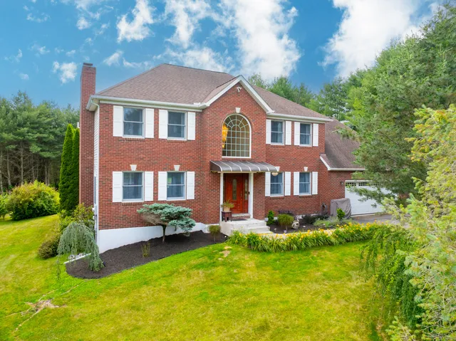 front view of brick house with a yard
