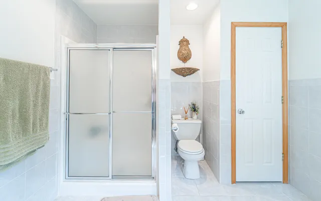 a view of a patio with table and chairs potted plants with wooden floor and fence