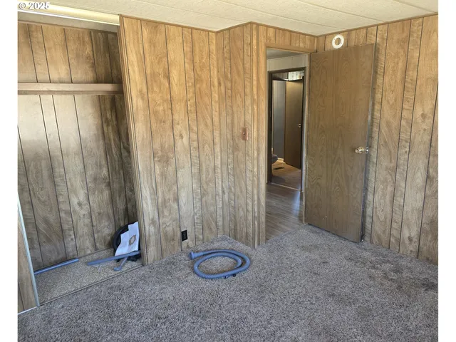 a view of a room with door and windows