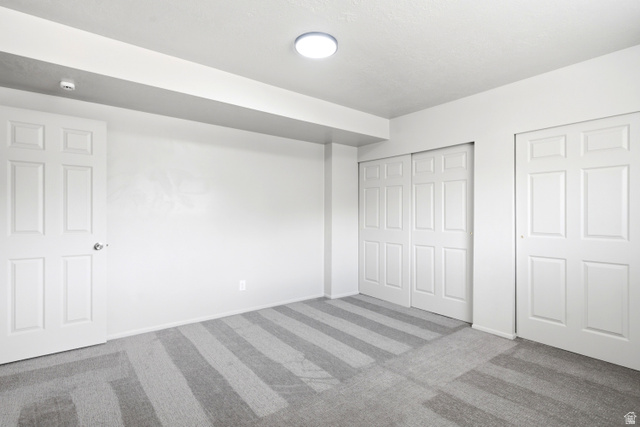 445 West 4900 South, Unit 2 Washington Terrace, UT 84405 - Photo 14 of 21 Interior room featuring a flush-mount ceiling light, white pnel doors, and two sets of sliding bifold closet doors