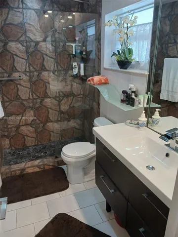 a bathroom with a sink toilet and mirror