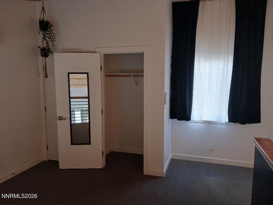 831 Ryland Street Reno, NV 89502 - Photo 14 of 26 a view of a hallway with wooden floor and a cabinet