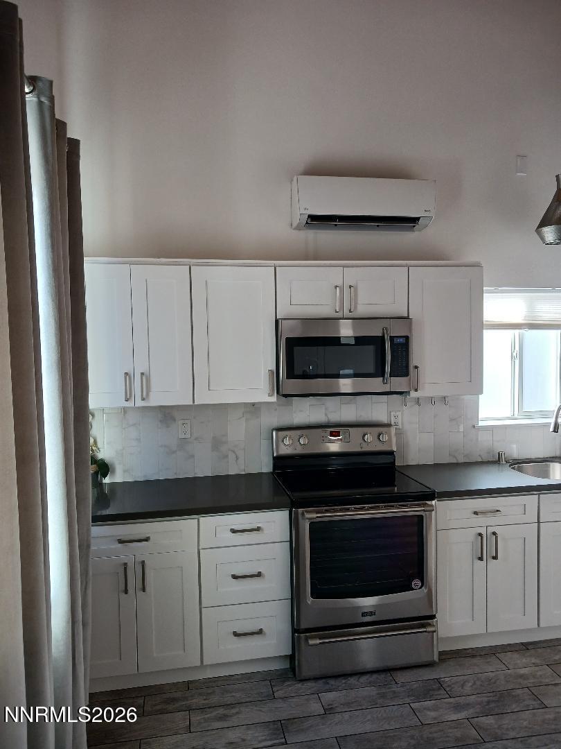 831 Ryland Street Reno, NV 89502 - Photo 2 of 26 a kitchen with stainless steel appliances granite countertop a stove and a refrigerator