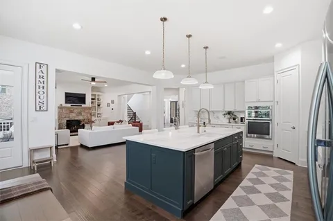 a kitchen with white cabinets and white appliances