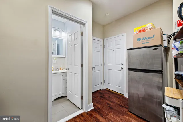 a view of walk in closet with wooden floor