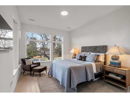 a bedroom with a bed and a night stand