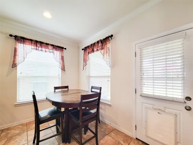 a view of a dining room with furniture and window