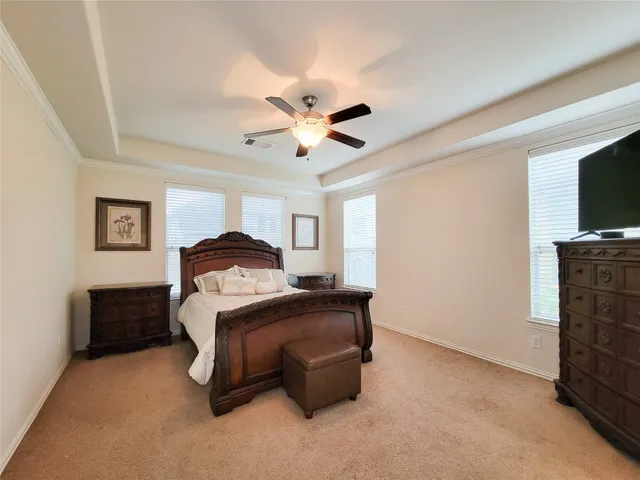 a bedroom with a bed and a television