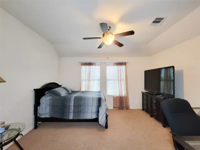 a bed sitting in a room next to a window