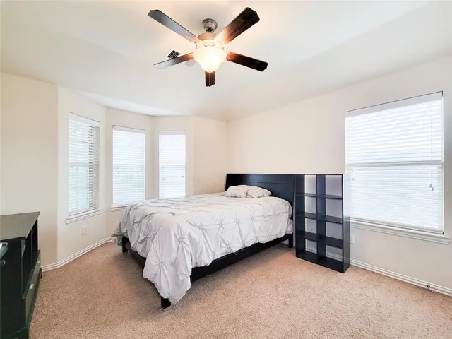 a bedroom with a bed a desk and chair