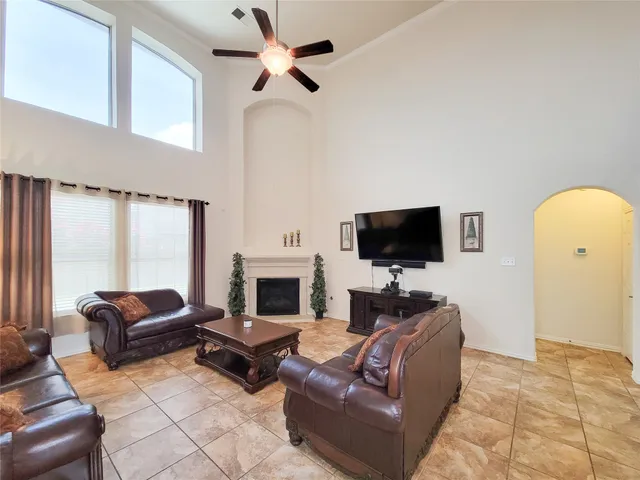 a living room with furniture a flat screen tv and a fireplace