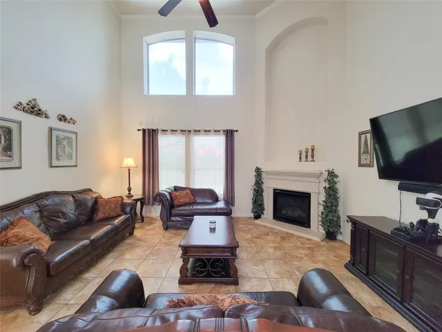 a living room with furniture fireplace and flat screen tv