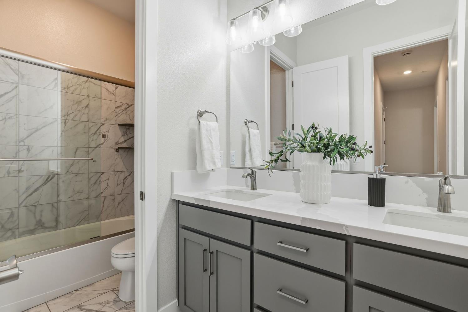 2121 Arbor Rdg Drive Roseville, CA 95747 - Photo 18 of 83 a bathroom with a granite countertop sink a toilet a mirror a vanity and shower