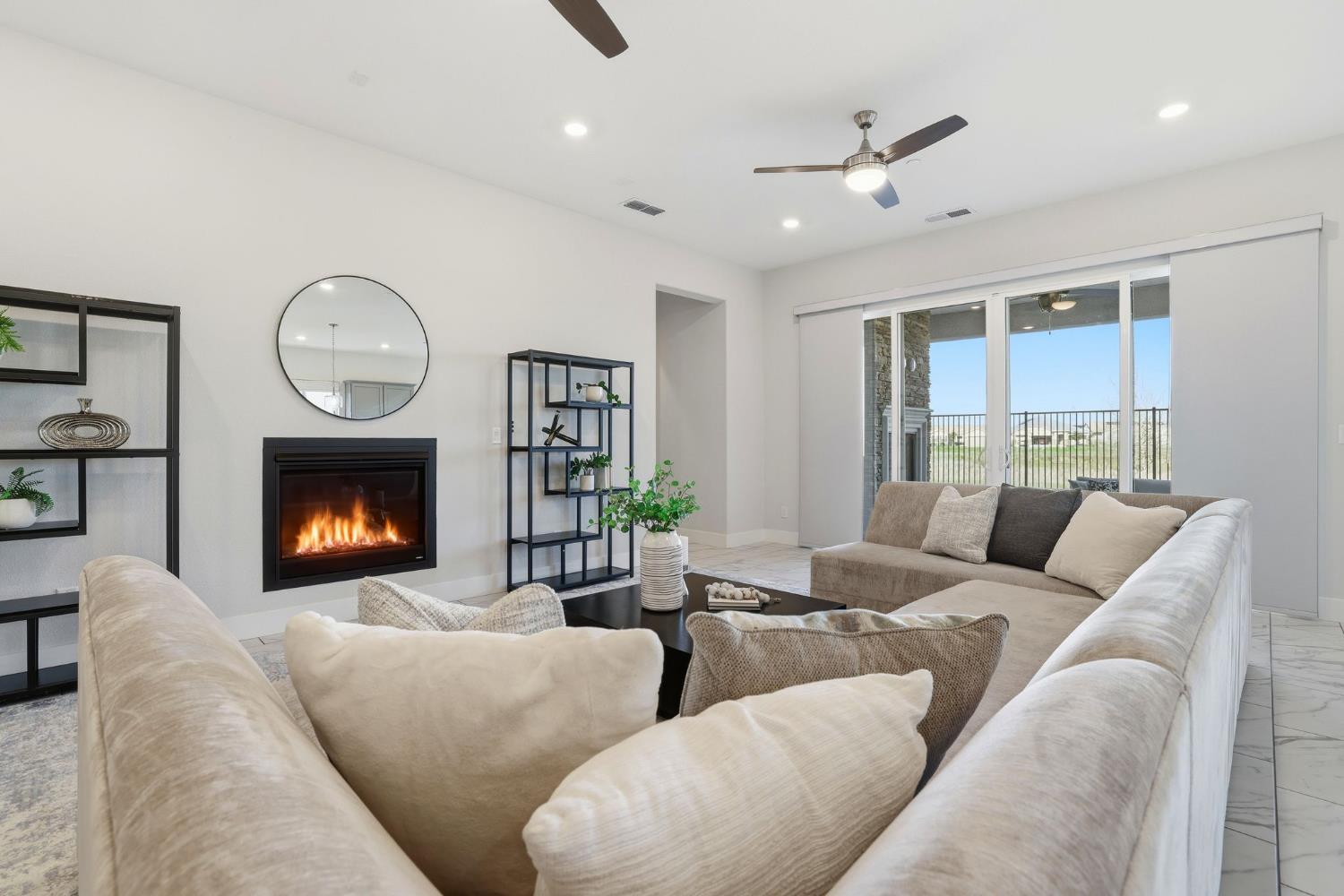 2121 Arbor Rdg Drive Roseville, CA 95747 - Photo 29 of 83 a living room with furniture a fireplace and a large window