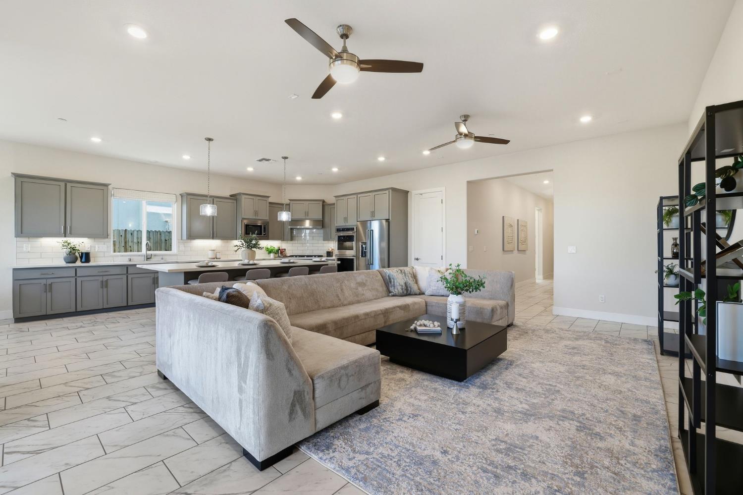 2121 Arbor Rdg Drive Roseville, CA 95747 - Photo 32 of 83 a large living room with stainless steel appliances kitchen island granite countertop a couch and a view of living room