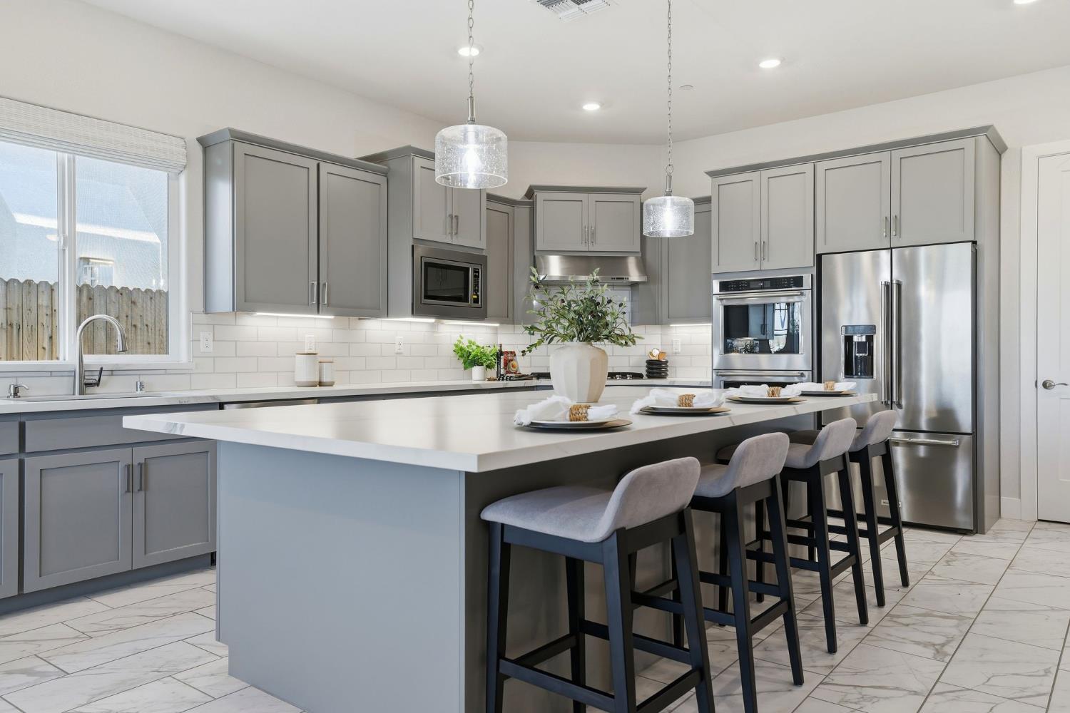 2121 Arbor Rdg Drive Roseville, CA 95747 - Photo 36 of 83 a kitchen with stainless steel appliances granite countertop a sink a stove a refrigerator and a dining table with wooden floor