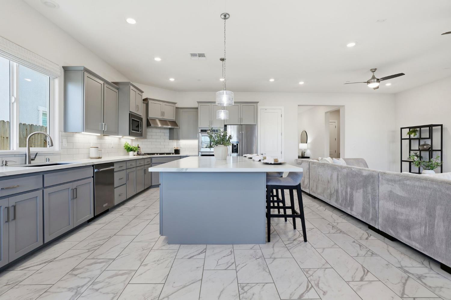 2121 Arbor Rdg Drive Roseville, CA 95747 - Photo 38 of 83 a kitchen with stainless steel appliances a sink a counter top space cabinets and a window