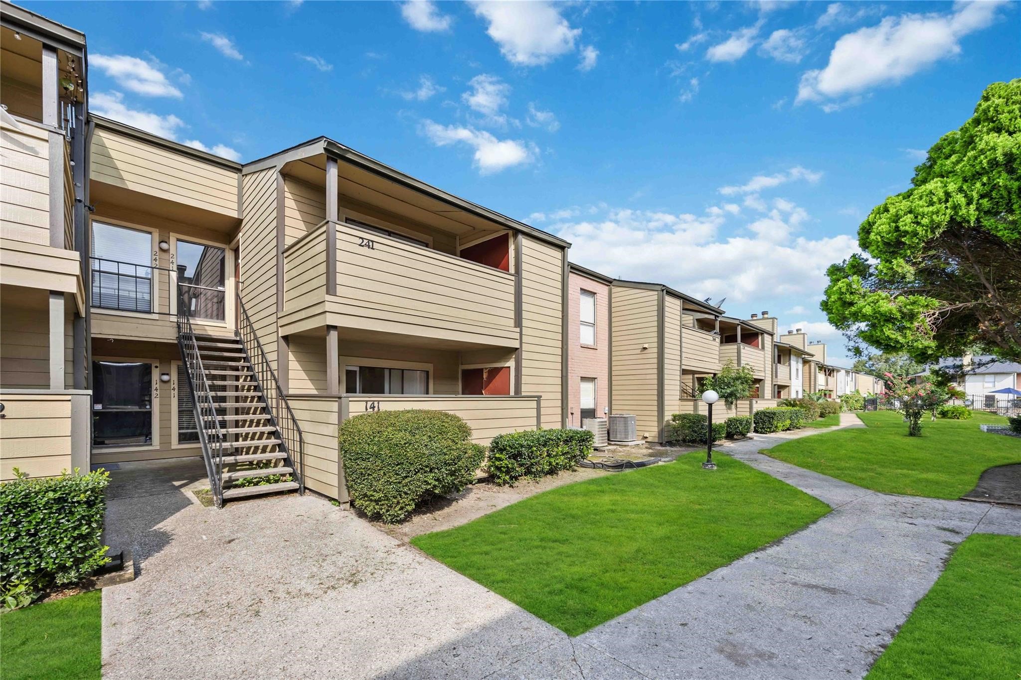 15534 Zabolio Drive, Unit 241 Houston, TX 77598 - Photo 1 of 21 a front view of a house with a yard