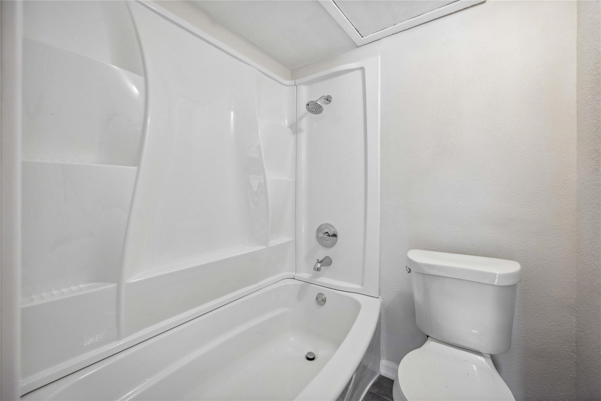 15534 Zabolio Drive, Unit 241 Houston, TX 77598 - Photo 17 of 21 a white toilet sitting next to a bath tub