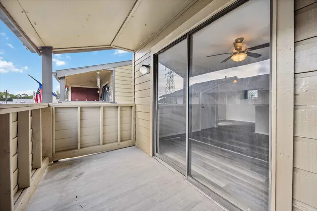 a view of a hallway with wooden shelves