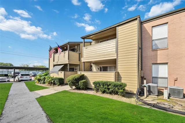 a front view of a house with a garden and plants