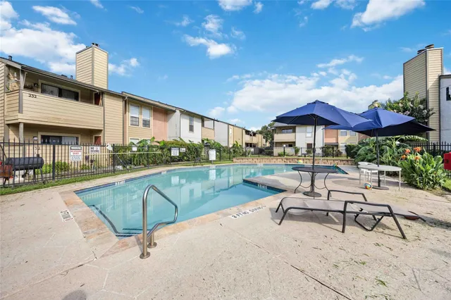 a swimming pool with outdoor seating and yard