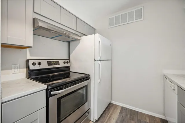 a kitchen with a stove and a microwave