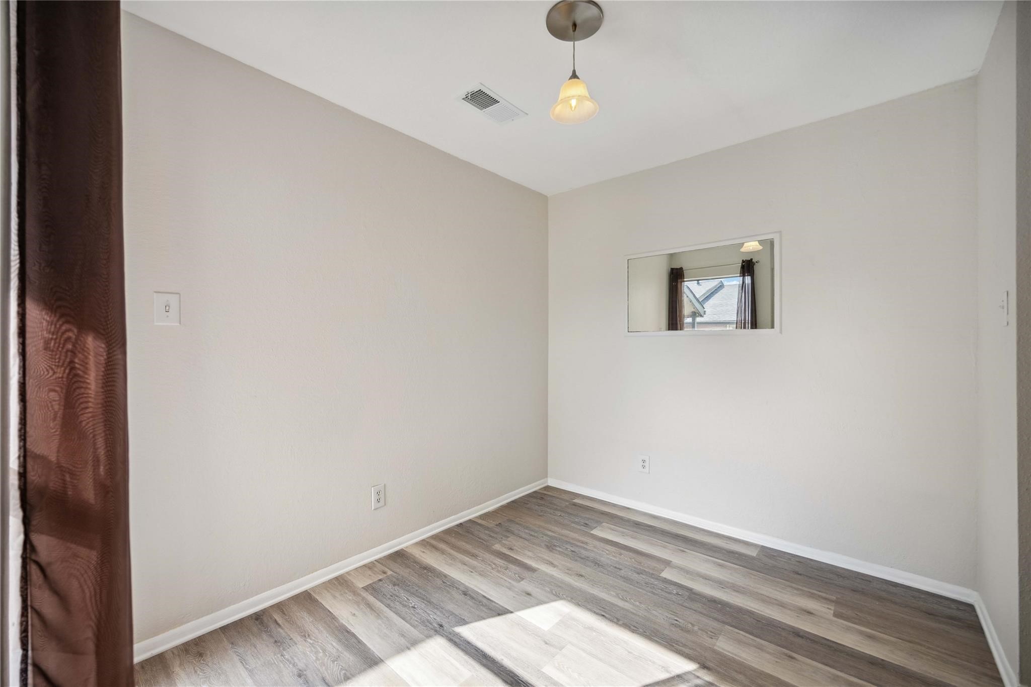 15534 Zabolio Drive, Unit 241 Houston, TX 77598 - Photo 10 of 21 an empty room with wooden floor and windows