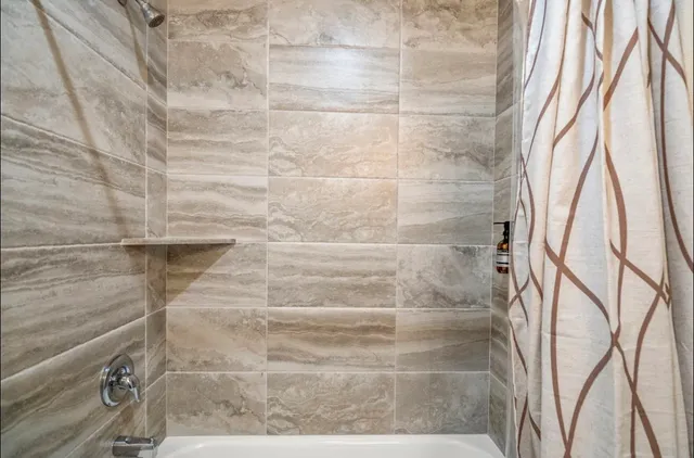 a bathroom with a granite countertop toilet sink and mirror