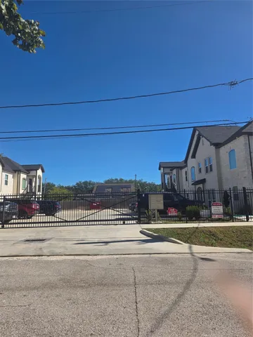 a view of a building and a car parked on the road