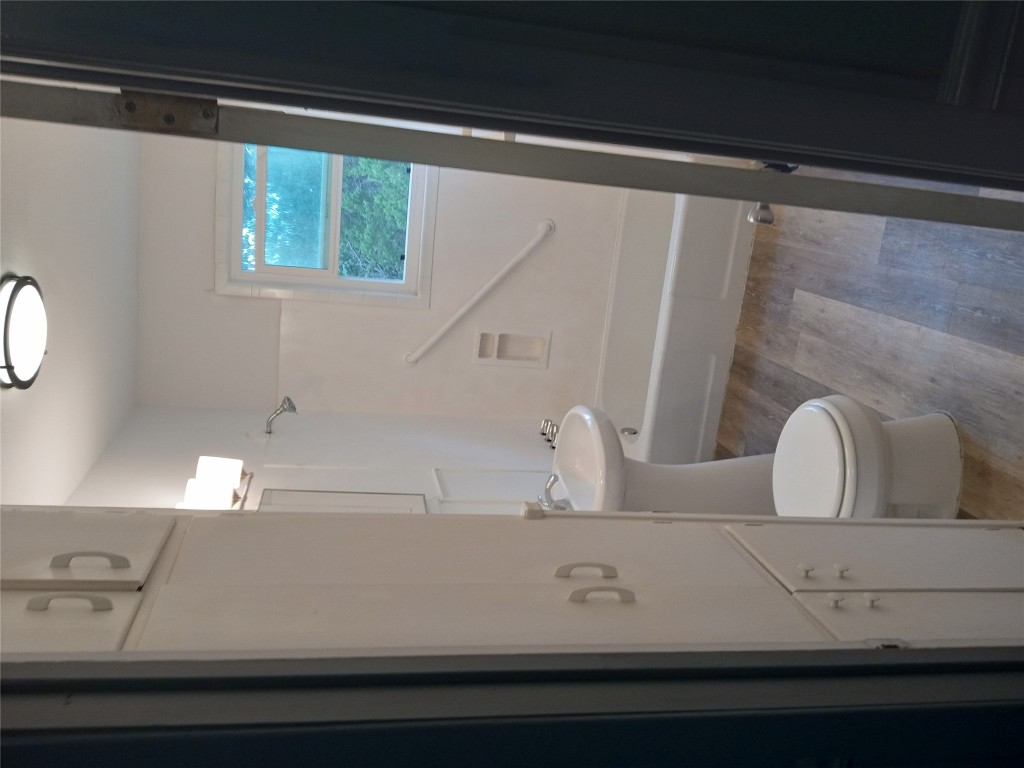 1505 Oreilly Court, Unit C Austin, TX 78734 - Photo 13 of 19 Bathroom featuring tub / shower combination and wood finished floors